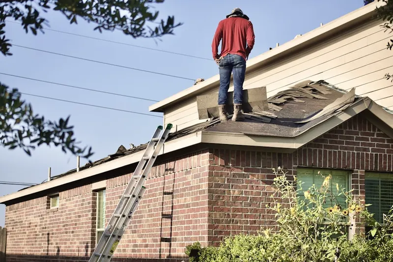 Professional roofer working on a residential roof in Leesburg